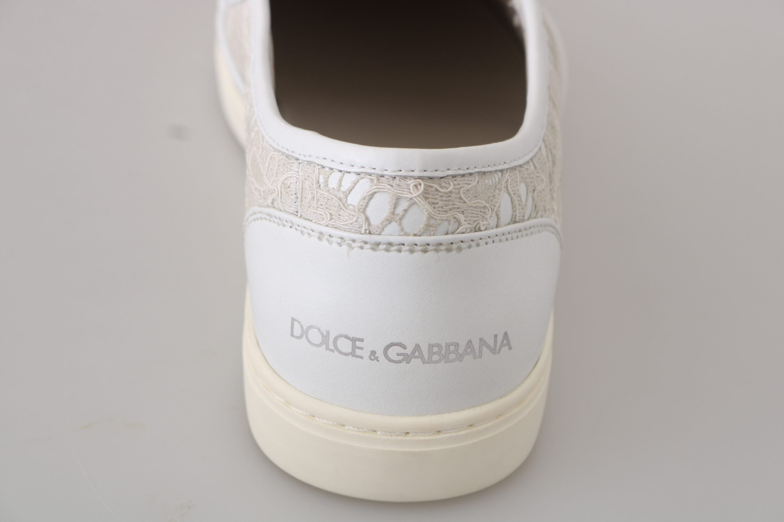 White leather lace slip-on loafers shoes by Dolce & Gabbana with sleek design and minimal stitching, displayed on a neutral background.