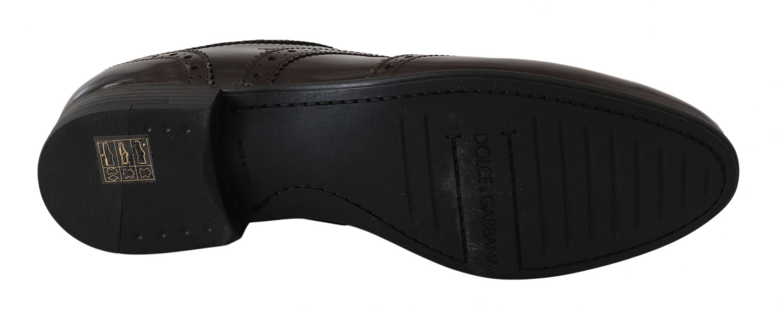 Brown leather brogue oxford wingtip shoes by Dolce & Gabbana, featuring detailed stitching and classic wingtip design.