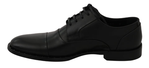 Black leather Derby formal shoes by Dolce & Gabbana, showing sleek design and polished finish on a plain background.