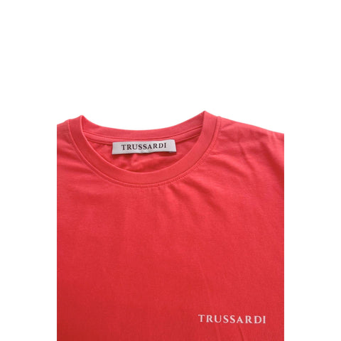Trussardi beachwear in salmon color, featuring a stylish design, displayed on a model at the beach.