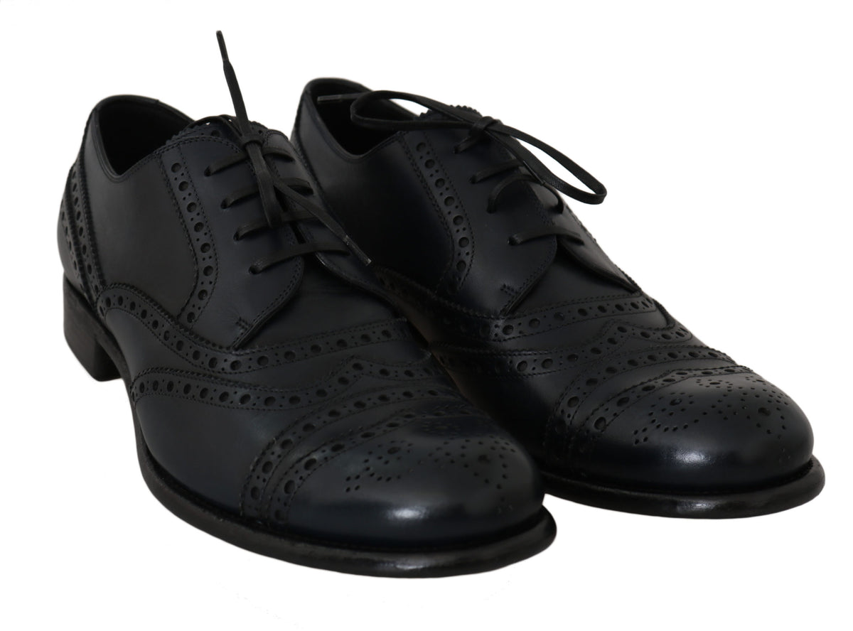 Dark blue leather wingtip Oxford dress shoes by Dolce & Gabbana, showing polished leather with brogue detailing and classic lace-up design.