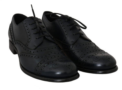 Dark blue leather wingtip Oxford dress shoes by Dolce & Gabbana, showing polished leather with brogue detailing and classic lace-up design.