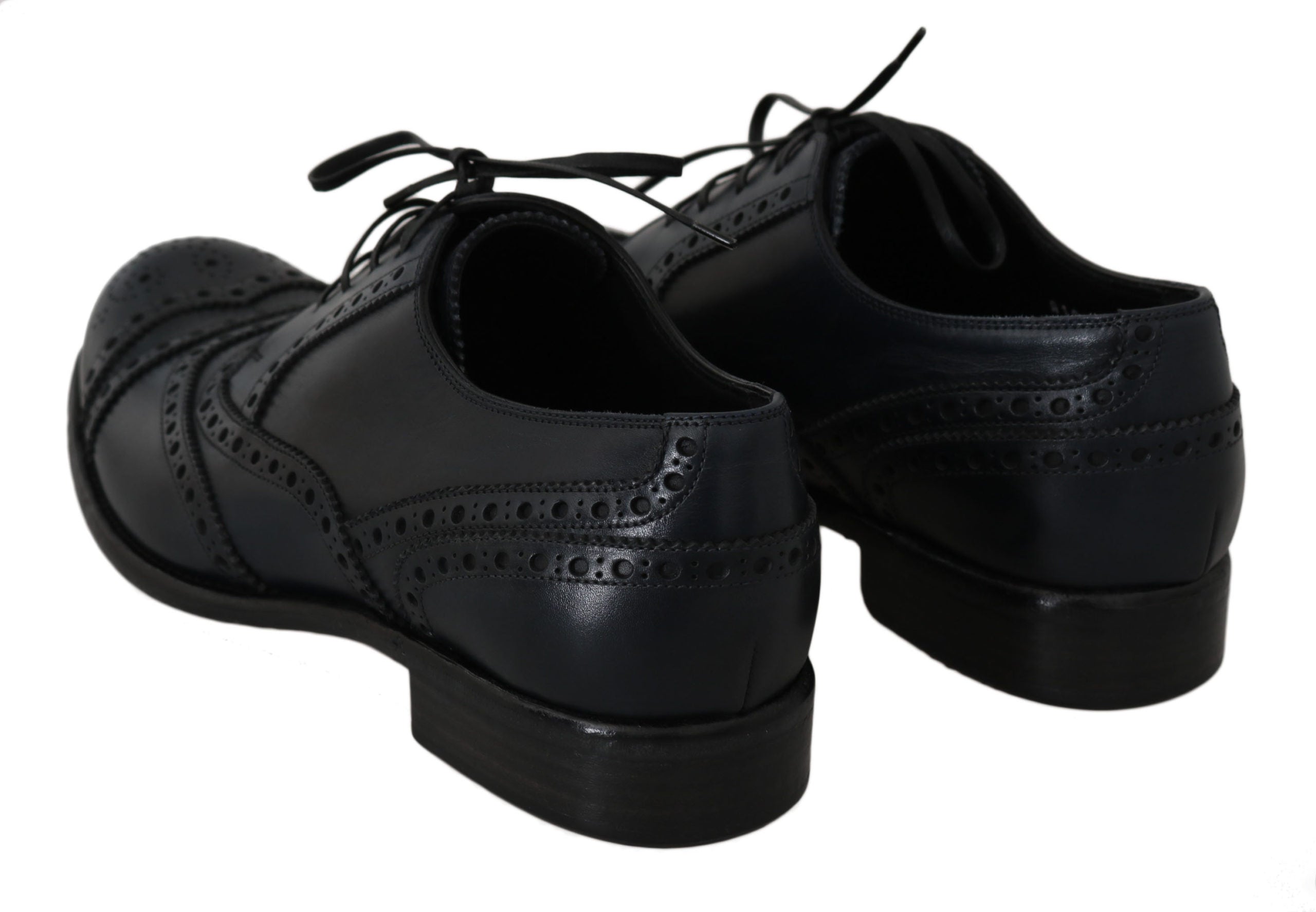Dark blue leather wingtip Oxford dress shoes by Dolce & Gabbana with detailed brogue accents and sleek polished finish.
