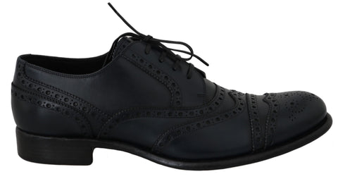 Dark blue leather wingtip oxford dress shoes by Dolce & Gabbana, featuring classic brogue detailing and sleek lace-up design.