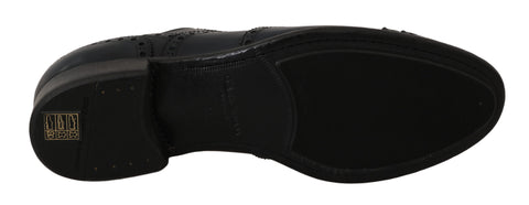 Dark blue leather wingtip Oxford dress shoes by Dolce & Gabbana with brogue detailing and sleek polished finish.