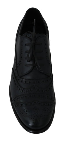 Dark blue leather wingtip Oxford dress shoes by Dolce & Gabbana, featuring classic brogue detailing and sleek lace-up design.