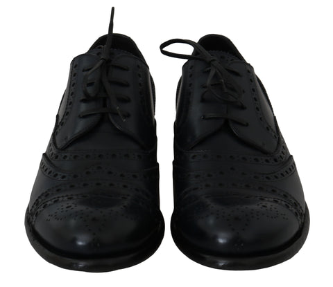 Dark blue leather wingtip oxford dress shoes by Dolce & Gabbana, featuring classic brogue detailing and sleek polished finish.