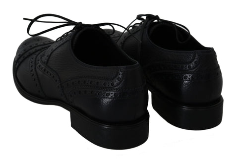 Blue leather wingtip Oxford dress shoes by Dolce & Gabbana, featuring classic brogue detailing and sleek, polished finish.