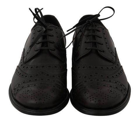 Black leather wingtip Oxford dress shoes by Dolce & Gabbana, featuring classic brogue detailing and sleek, polished finish.