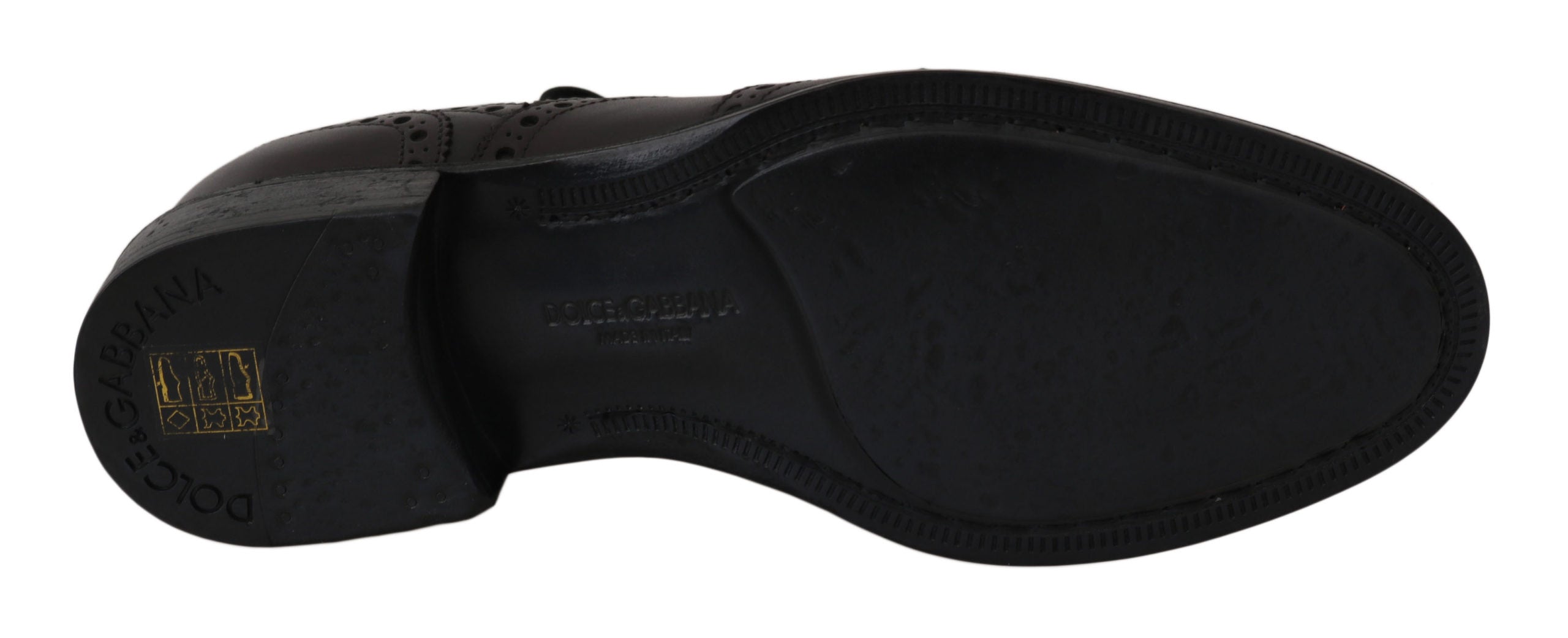 Black leather wingtip Oxford dress shoes by Dolce & Gabbana with detailed brogue pattern and classic lace-up design.