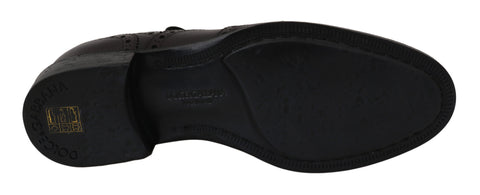 Black leather wingtip Oxford dress shoes by Dolce & Gabbana with detailed brogue pattern and classic lace-up design.