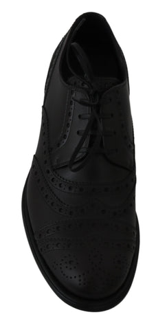 Black leather wingtip Oxford dress shoes by Dolce & Gabbana with detailed brogue accents and classic lace-up design.