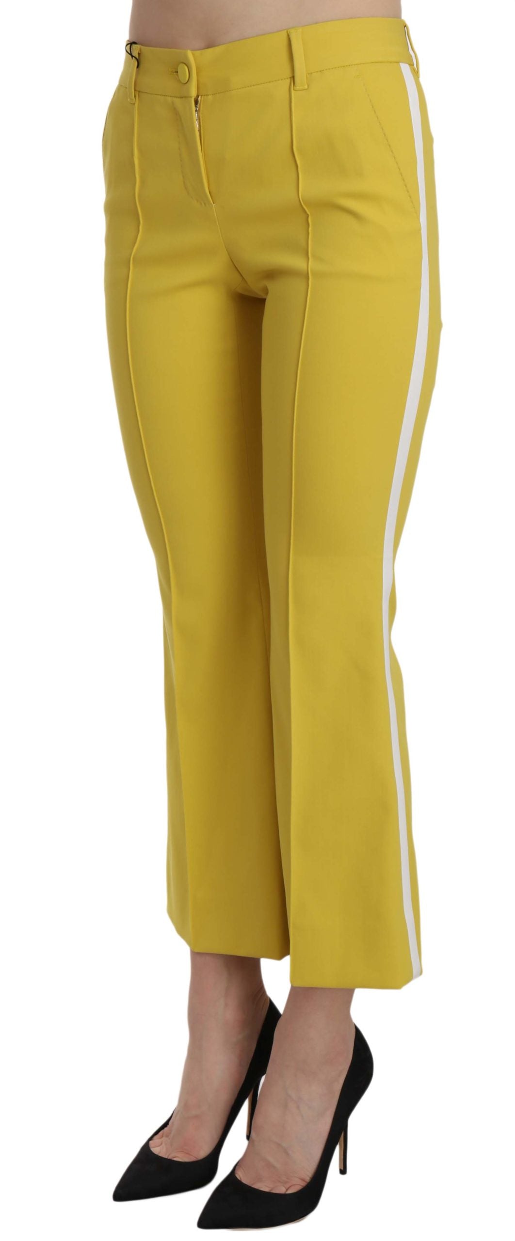 Yellow flared bootcut cotton capri pants by Dolce & Gabbana, shown on a hanger with a close-up of fabric texture.