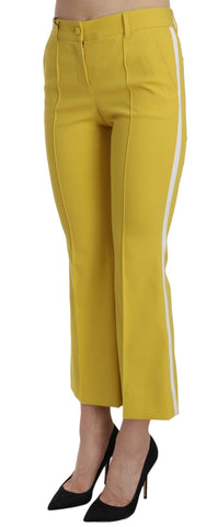 Yellow flared bootcut cotton capri pants by Dolce & Gabbana, shown on a hanger with a close-up of fabric texture.