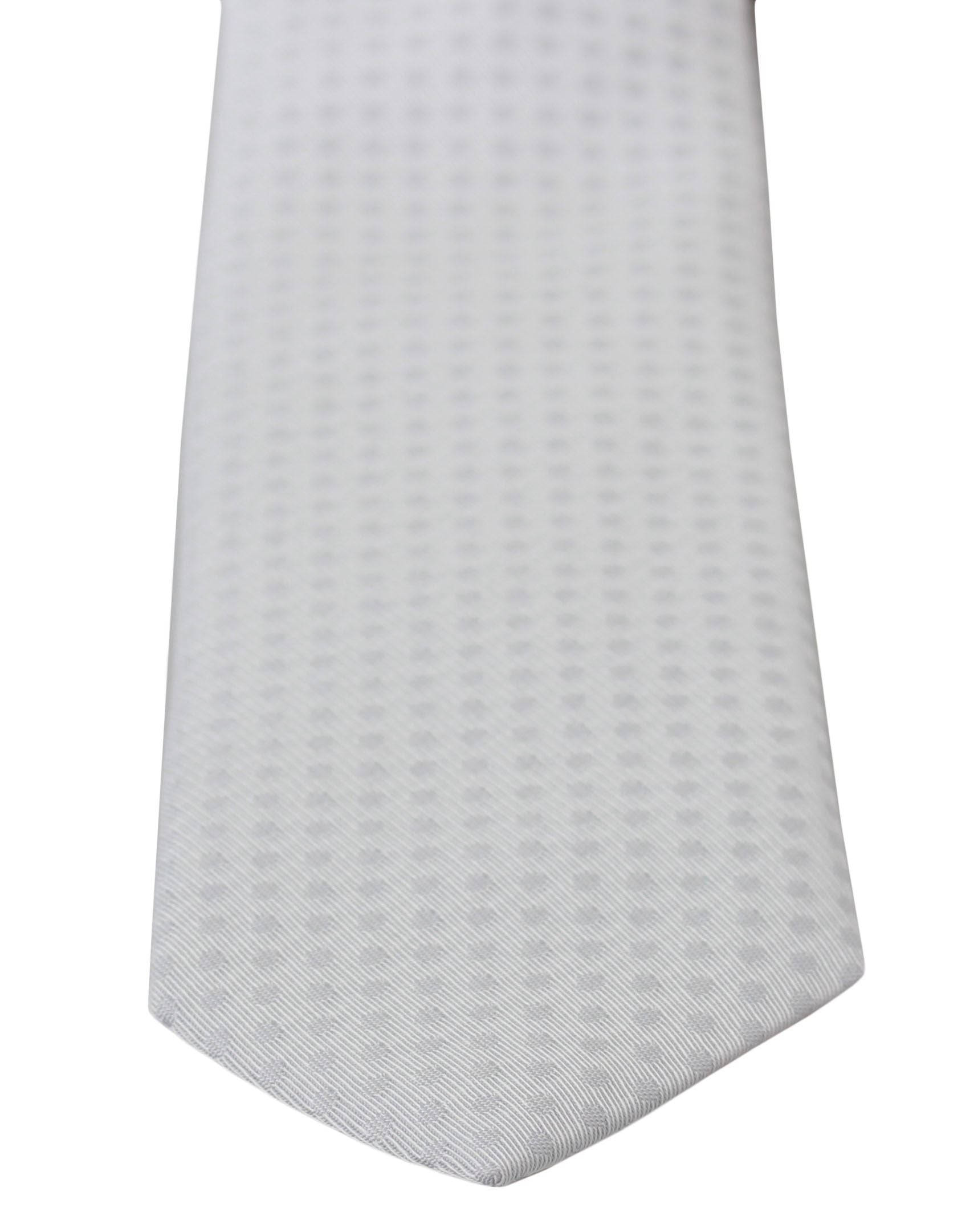 White patterned classic men's slim necktie by Dolce & Gabbana showing the detailed design and smooth fabric texture.