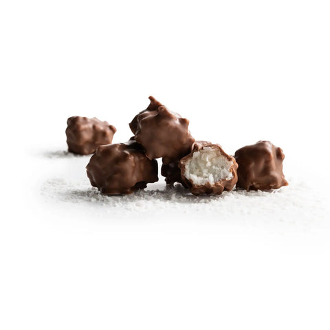 Milk chocolate covered amaretto-flavored coconut pieces called Amaretto Rocks by Jag Couture London, shown in a close-up image.