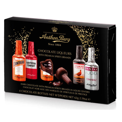 Assorted Anthon Berg 4-piece chocolate liqueurs by Jag Couture London New York on a plate with decorative packaging.