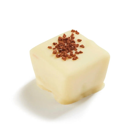 Anton tiramisu flavored milk ganache in white chocolate, 13.4g, shown in a close-up of the creamy, smooth chocolate confection.