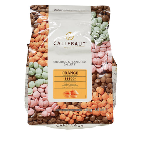 White chocolate callets with orange flavor from Jag Couture London - New York, shown in a close-up image.