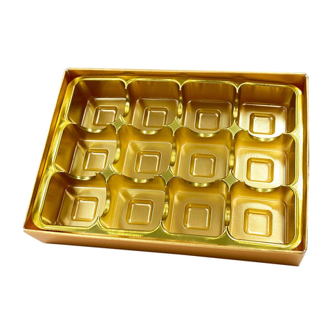 Gold chocolate base, vacuum tray, and cello lid in a box by Jag Couture London New York, ideal for luxury confectionery packaging.