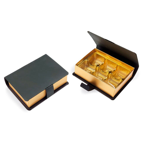 Six hinged lid chocolate book box with gold vacuum tray, measuring 110x80x32mm, by Jag Couture London New York.