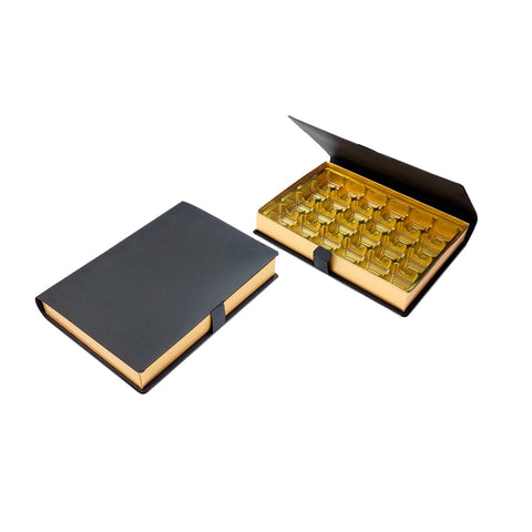 Jag Couture London - New York 24-chocolate hinged lid book box with gold vacuum tray, measuring 217 x 157 x 32 mm.