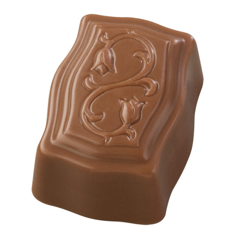 Jag Couture London milk praline with coconut in a 15.3g Cocoly package, showcasing the creamy coconut-filled chocolate treat.