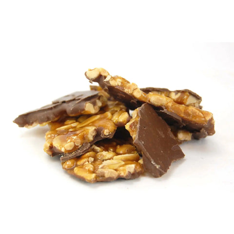 Half-coated milk chocolate choco peanut brittle by Jag Couture London New York, showing crunchy peanuts and smooth chocolate coating.
