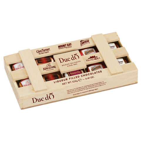 Duc d'O wooden crate of assorted liqueur-filled chocolates with sugar crust by Jag Couture London - New York, shown in the image.