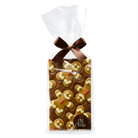 Milk chocolate bar decorated with gingerbread person design in a clear cello bag, by Jag Couture London New York.