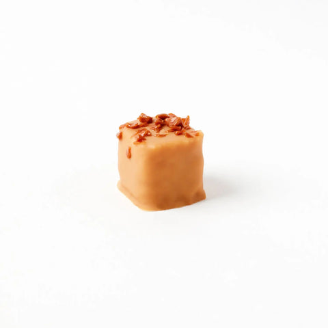 Salted butter caramel chocolate-covered coconut praline from Jag Couture London, 15g, with rich caramel and coconut coating.