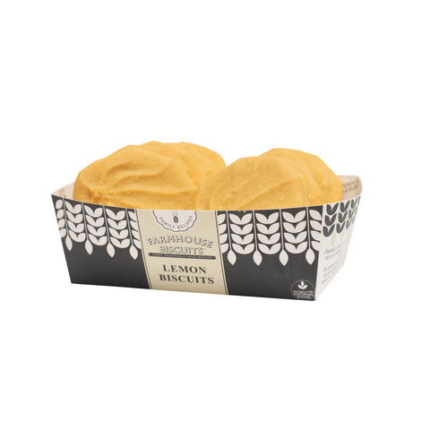 Farmhouse lemon biscuits in a tray by Jag Couture London, showcasing golden, lemon-flavored biscuits arranged neatly.