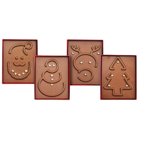Assorted solid milk chocolate Christmas-themed games in mixed cases by Jag Couture London New York, featuring festive designs and packaging.