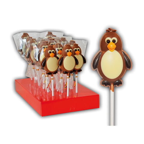 Hand-decorated chocolate penguin lollipops displayed in a decorative arrangement, crafted by Jag Couture London - New York.