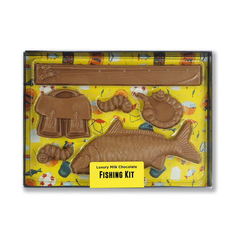Milk chocolate fishing kit in black gift box with clear lid, by Jag Couture London - New York, displayed with chocolates inside.