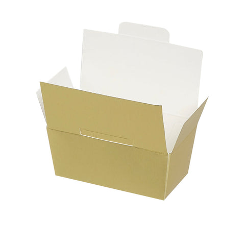 Two matte gold ballotin boxes with chocolate, from Jag Couture London - New York, shown in a sleek, elegant presentation.