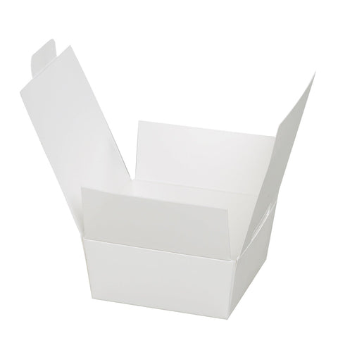 Assorted white chocolate ballotin from Jag Couture London New York, featuring elegant packaging with four chocolates.