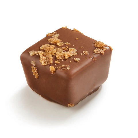 Halliday Milk praline with feuilletine in milk chocolate by Jag Couture London, 14g, showing a glossy chocolate treat with crunchy filling.