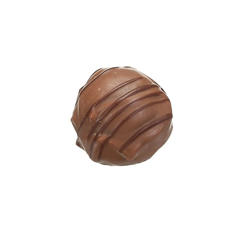 Milk chocolate enrobed gin and elderflower truffle by Jag Couture London, showcasing a delicate 13g confection with floral and botanical flavors.
