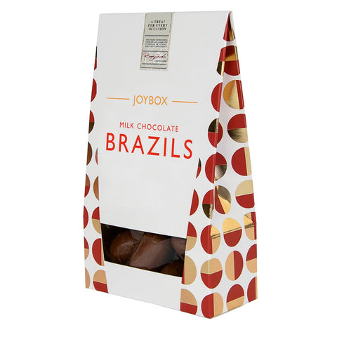 Milk chocolate-coated Brazil nuts in a carton from Joybox by Jag Couture London New York, ready to enjoy as a snack.