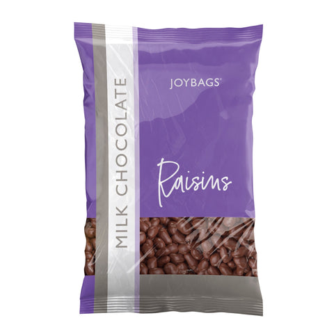 Joybags milk chocolate covered raisins by Jag Couture London - New York, close-up of glossy milk chocolate-coated raisins in a bowl.