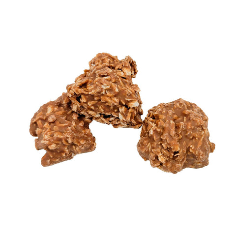 Milk chocolate covered coconut clusters by Jag Couture London - New York, showing creamy coconut pieces coated in smooth milk chocolate.