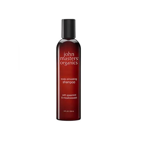 John Masters Organics Scalp Stimulating Shampoo bottle in clear 236ml container, displayed on a clean surface.