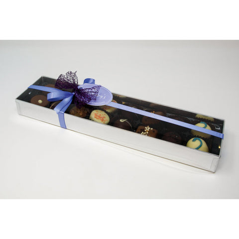 Assorted handmade English chocolates and truffles in a silver gift box with menu tag, by Jag Couture London New York.