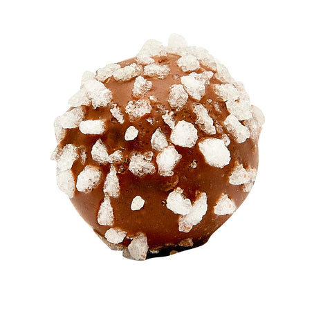 Milk chocolate Prosecco truffle by Jag Couture London, filled with fresh cream and Grappa di Prosecco, shown in close-up.
