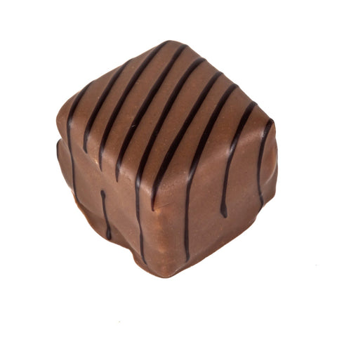Milk Noisette praline by Jag Couture London with milk chocolate, chopped hazelnuts, and hazelnut pieces in a 13g piece.