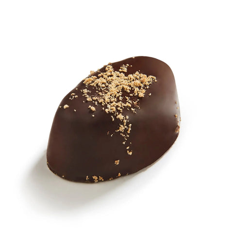 Dark chocolate bar with caramel ganache from Linde by Jag Couture London, showing a close-up of the chocolate piece with glossy caramel filling.