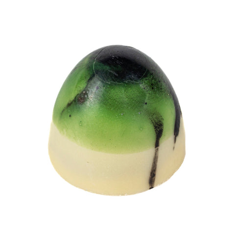 White chocolate coconut bullet with milk chocolate coconut and lime ganache, showcasing a luxurious treat by Jag Couture London.