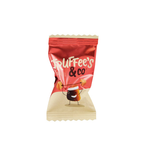 Assorted salted butter caramel French truffles with cocoa dust, wrapped in red flow wrap by Jag Couture London New York.