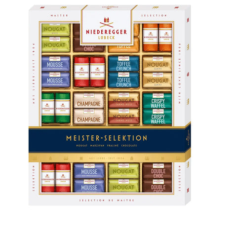 Assorted bite-sized marzipan, praline, and chocolate confections from Jag Couture London New York, displayed in a luxurious box.